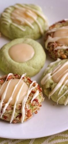 several cookies with icing on a white plate