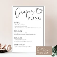 a paper pong party sign next to some wooden pegs on a white table