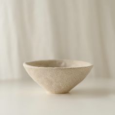 a white bowl sitting on top of a table