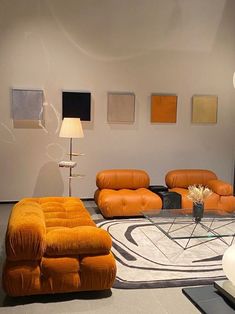 a living room filled with orange couches and chairs