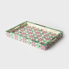 a green, pink and white patterned tray