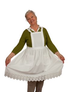 an older woman in a white dress and green sweater