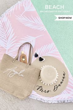 the beach bag is next to a hat and sunglasses on top of a pink towel