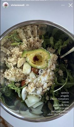 a salad with an avocado on top in a bowl