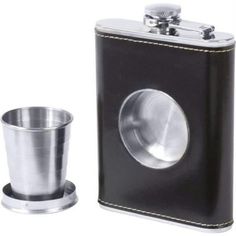 a flask and shot glass are sitting next to each other