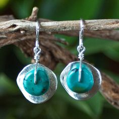 "Silver Cornflake Disc Earrings with Turquoise - Silver and Turquoise Earrings - Turquoise Earrings - Unusual Earrings Wavy \"cornflake\" beads plated in fine silver are topped with genuine turquoise rondelles in these turquoise drop earrings. They dangle from sterling silver French earwires. These silver and turquoise earrings are like a ray of summer sunshine and have proven to be one of the most popular earring styles offered in our Ambrosia Collection. Imported from Greece, the wavy \"cornfl Artisan Turquoise Nickel-free Earrings, Artisan Nickel-free Turquoise Earrings, Round Turquoise Earrings For Gift, Unique Turquoise Dangle Earrings, Artisan Turquoise Pierced Earrings, Adjustable Turquoise Earrings With Ear Wire, Turquoise Round Pierced Jewelry, Unique Turquoise Teardrop Earrings, Turquoise Round Sterling Silver Earrings