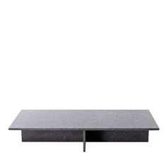 a black table sitting on top of a white wall