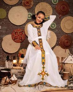 Menen Habesha Dress – ብርሃን Long Cotton Dresses For Eid, White Folk Dress For Eid, Cotton Tunic Dress For Eid, Long Sleeve Folk Dress For Eid, Folk Style Long Sleeve Dress For Eid, Traditional Cotton Midi Dress, Folk Style Festive Tunic Dress, Festive Folk Tunic Dress, Folk Style Tunic Dress For Eid