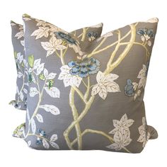 two decorative pillows with blue flowers on them