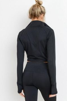 Keep your wrists and your neck warm whilst showing a little bit of skin in this solid-colored crop jacket. The long sleeves have thumb holes and the jacket zips all the way up. 88% polyester, 12% spandex.Moisture wicking.Four-way stretch. Cropped Black Jacket, Athleisure Pants, Active Jacket, Black Zip Ups, Active Women, Thumb Holes, Crop Jacket, We Wear, Black Jacket