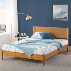 a bedroom with blue walls and wooden furniture