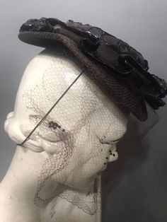 A rather fab 1940s tilt hat with a wonderful long veil. The wired brim is covered with a jersey type fabric and there is a mesh frill on the br with raffia border. The crown is covered in raffia. The hat doesn't have a label. Due to design this is a one size fits all hat and there is an elastic to hold it in place. 1950s Prom Dress, 50s Outfits, Feather Fan, Long Veil, Ostrich Feathers, 50s Fashion, Hats Vintage, The Crown, No Frills