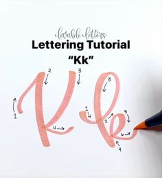 the letters k and l are drawn on a piece of paper with a pencil in it