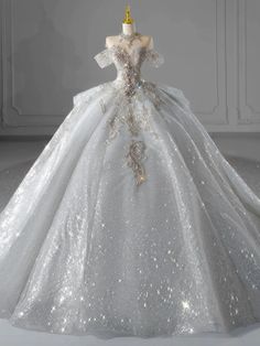 a white wedding dress with sequins on the skirt