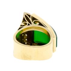 This is part of Chairish’s Fine Jewelry assortment.  This extraordinary ring is meticulously crafted from high-quality 18k yellow gold, creating a stunning piece of jewelry that exudes luxury and elegance. The intricate abstract design of the ring incorporates a striking chrysoprase stone as its focal point, complemented by seven small single-cut diamonds that sparkle brilliantly in the light. Notably, the diamonds are carefully set in lustrous white gold on one side of the ring, adding a captiv Luxury Yellow Gold Opal Ring, Elegant Green Opal Ring In 14k Gold, Elegant Green Intaglio Ring, Luxury 14k Gold Opal Ring, Luxury Green Intaglio Rings, Luxury Formal Rings With Unique Design, Luxury Formal Ring With Unique Design, Luxury Rings With Unique Design For Formal Occasions, Luxury Yellow Gold Opal Ring With Polished Finish