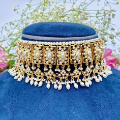 Featuring a classic broad pearl choker necklace matched with a magnificient pair of edwardian era style earrings, made in sterling silver with 22K gold plating. Ideal for wedding functions and will go with any south asian attire. It has been embellished with freshwater pearls. Weight - 110 GMs for the full set with earrings weighing 30gms Default Materials in Our Gold Plated Jewellery Metal: 925 Sterling Silver Studded Stones: Precious freshwater pearls, synthetic red,green,blue stones that rese Jadau Set, Seed Pearl Jewelry, Pearl Choker Set, Asian Attire, 22k Gold Jewelry Necklaces, Jadau Jewellery, Silver Pearl Jewelry, Pearl Necklace Set, Pakistani Jewelry