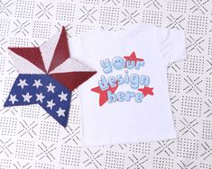 "July 4th White Bella Canvas 3001T Mockup, Toddler White Tshirt Mockup Short Sleeve T-shirt Mock Up Kids Flat Lay T-shirt Mock Up 4th of July ♥ WHAT'S INCLUDED ♥ 1 JPG file free of any text or watermarks - 300ppi large resolution ♥ NOTE ♥ This is an instant DIGITAL DOWNLOAD. No physical items will be mailed to you. The digital files will be available for download directly from Esty seconds after the purchase. ♥ INSTRUCTIONS ♥ DOWNLOADING: After you make the purchase, Etsy will take you to the do Patriotic Short Sleeve Top With Custom Print, Custom Print Short Sleeve Tops For Independence Day, Customizable Short Sleeve Tops For Fan Merchandise, Customizable Short Sleeve Fan Merchandise Tops, Customizable Fan Merchandise Short Sleeve Tops, Independence Day Custom Print Short Sleeve Tops, Short Sleeve Tops With Custom Print For Independence Day, Independence Day Short Sleeve Tops With Custom Print, 4th Of July Custom Print Crew Neck Top