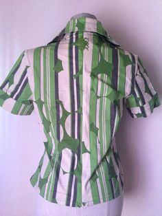 "Green Wrap Shirt, Japanese style 70s style with pointed collars Stunning patterned wrap blouse featuring green vertical stripes mixed with green circles and other abstract prints Wrap waist with button fastening Short sleeves, pointed collar, V-neckline, cotton fabric, low waist zipper Amazing combination of style! Asian bodice and collars with 70's references So cool abstract pattern, comfy fitting and absolutely trendy and hip looks! A unique 90's vintage piece, in great condition. ‼️Be aware Green Retro Print Shirt For Spring, Retro Green Collared Shirt, Retro Green Printed Tops, Green Retro Print Short Sleeve Tops, Green Short Sleeve Tops With Retro Print, Green Shirt With Abstract Print For Spring, Retro Green Shirt For Spring, Fitted Green Tops With Retro Print, Fitted Green Top With Retro Print