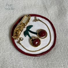 a red and white plate with some jewelry on it