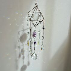 Step into a realm of tranquility and spiritual insight with our Amethyst Dreams suncatcher, featuring a raw Amethyst cluster and delicate Amethyst beads. Key Benefits & Features: Healing Energy: Adorned with raw, natural Amethyst and Amethyst beads, this suncatcher radiates serene and protective energy. Unique Artisan Craftsmanship: Each suncatcher is handcrafted with care, ensuring that no two pieces are alike. Tranquil Atmosphere: Hang in windows, gardens, or any space where sunlight can illum Mystical Raw Stone Crystals For Healing, Mystical Healing Raw Stone Crystals, Silver Mystical Crystals For Meditation, Bohemian Silver Crystals For Meditation, Bohemian Purple Amethyst Crystals, Spiritual Lavender Gemstone Crystals, Lavender Gemstone Crystals For Spiritual Use, Purple Spiritual Crystals For Jewelry Making, Spiritual Lavender Crystals