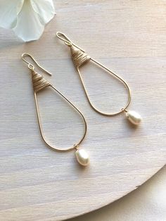 Espanol abajo! Pretty teardrops that are classic and chic. That rare style that's perfect both for every day and special occasions. Gold filled wire, hand forged ear wires and a white pearl. About 2 inches in length. Hermosos pendientes en forma de gota que son ambos clásicas y elegantes. Ese estilo único que es perfecto tanto para el día a día como para ocasiones especiales. Hechas con alambre relleno de oro, ganchos forjados a mano y una perla blanca. 2.5" long 2.5 puIgadas de largo Elegant Adjustable Teardrop Earrings, Elegant Adjustable Teardrop Earrings With Pearl Drop, Adjustable Nickel-free Teardrop Pearl Earrings, Adjustable Teardrop Pearl Drop Earrings, Minimalist Teardrop Pearl Drop Earrings, Elegant Adjustable Pearl Drop Teardrop Earrings, Everyday Teardrop Pearl Earrings With Ear Wire, Elegant Teardrop Earrings With Pearl Drop, Nickel-free Teardrop Pearl Earrings