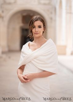 a woman in a white dress posing for a photo