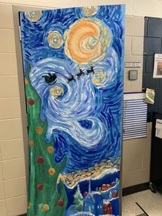 an art project is being displayed on the wall in front of a classroom door that has been decorated with blue, yellow and white paint