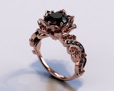 a rose shaped ring with black diamonds on it