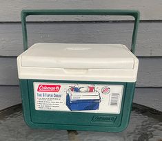 a green and white cooler sitting on top of a table