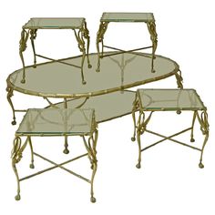 a set of three tables with glass top and gold metal frame, all in the same design