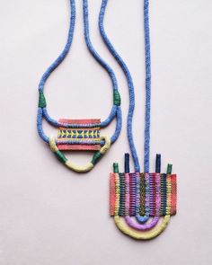 two necklaces made out of beads on a white surface, one is blue and the other has multicolored beading