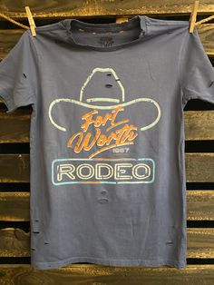 Country Deep Fort Worth 80's Rodeo vintage unisex distressed T shirt in vintage wash black and faded Navy Throw back vintage tee from 1980's 40 Singles Jersey 100% Cotton Premium quality ringspun and compacted cotton Fine Cotton Jersey that is pigment dyed for a more vintage look Features tears and destroyed features at neck and on body Each piece is unique as this process is done by hand! 3.8 oz Made In USA Every garment dye item can be a slightly different shade in color since this is a laundr Retro Faded T-shirt With Letter Print, Faded Distressed Crew Neck T-shirt, Vintage Distressed T-shirt With Relaxed Fit, Retro Distressed Faded T-shirt, Vintage Faded T-shirt With Screen Print, Vintage Acid Wash Distressed T-shirt, Distressed Tri-blend Graphic Tee, Retro Distressed Crew Neck T-shirt, Vintage Faded Short Sleeve T-shirt