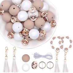 a bowl filled with lots of white and brown beads next to some accessories on a table