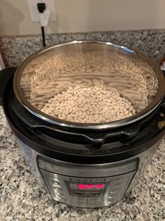 a crock pot filled with beans sitting on top of a counter