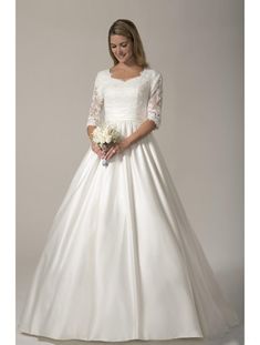 a woman in a white wedding dress holding a bouquet