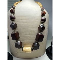 The vintage geometric large wooden bead necklace is a striking and contemporary piece of jewelry that blends natural elements with modern design. The necklace features oversized wooden beads, each meticulously carved into geometric shapes. The use of wood adds a rustic and earthy feel to the necklace, while the geometric shapes infuse it with a sense of sophistication and edginess. Size: 28" Excellent Vintage Condition Artisan Wooden Beads Jewelry, Artisan Wooden Bead Jewelry, Artisan Jewelry With Wooden Beads, Artisan Wooden Beads Jewelry In Natural Wood, Artisan Natural Wood Jewelry With Wooden Beads, Brown Jewelry With Wooden Beads, Brown Wooden Beaded Jewelry, Natural Wood Necklaces With Wooden Beads, Wooden Bead Necklace