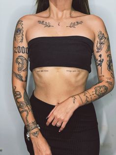 a woman with tattoos on her arms and chest