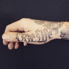 a person's hand with a tattoo on it and the word life written in cursive writing