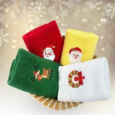 christmas towels in a basket with santa claus on the front and snowflakes behind them