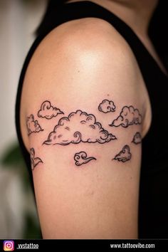 a woman with a cloud tattoo on her shoulder