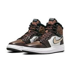 Introducing the Nike Womens Air Jordan 1 Acclimate Chocolate! This sneaker-boot hybrid is perfect for those cold winter days. The upper is made of brown and white leather, with rolled edges and a rubberized heel overlay. The lacing system includes speed hooks and D-ring eyelets. The quilted textile collar and tongue feature a faux fur lining. Above the white rubber midsole is a matching white rubber wrap. The brown cored-out rubber outsole provides grip and durability. Air Jordan 1 Acclimate, Womens Air Jordan 1, Womens Air Jordan, Wmns Air Jordan 1, Womens Air Jordans, Outfit Plan, Nike Womens, Winter Days, Air Jordan 1