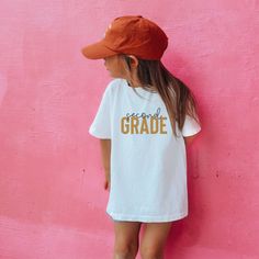 This tee is perfect for your kiddos to wear to school on any occasion! We are honored to make and design tee to fit your everyday needs. .: Made with 100%, midweight (5.3 oz/yd² (180 g/m US cotton that feels soft to the touch and a great choice for any season. .: All t-shirts come with tear-away labels for total comfort and a scratch-free experience. .: Fabric blends: Heather colors - 50% cotton, 50% polyester,  Sport Grey - 90% cotton, 10% polyester. -Processing 7-9 business days -Please make purchases with ample time Casual Name Print T-shirt For Back To School, Short Sleeve T-shirt For School Events In Summer, Casual T-shirt With Name Print For School Events, Casual School T-shirt With Name Print, Casual T-shirt With Name Print For School, Cute Cotton T-shirt For School Events, Casual Letter Print T-shirt For School Events, Cute White T-shirt For College, Cute White College T-shirt