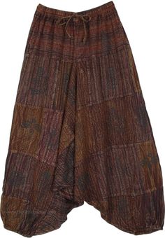 A smart pair of Aladdin style drop crotch pants that transport you back in time, these stonewashed effect loose pants are unique. With their patchwork style brown monochromatic pieces together, the pants have a traditional set of motifs on top which highlights the backdrop. #tlb #SplitSkirtsPants #Patchwork #bohemianfashion #Handmade #AladdinPants #DropCrotchpants #HaremPants #UnisexPants Brown Patchwork Wide Leg Bottoms, Festival Brown Patchwork Bottoms, Brown Patchwork Long Pants, Baggy Brown Patchwork Bottoms, Brown Baggy Patchwork Bottoms, Hippie Style Wide Leg Brown Bottoms, Brown Wide Leg Hippie Bottoms, Bohemian Brown Wide Leg Harem Pants, Hippie Style Brown Harem Pants For Festival