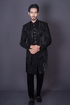 Bold black jacket featuring intricate hand embroidery done with stones, cutdana and sequins. Comes with a sleeveless sherwani and pant. - Aza Fashions Traditional Fitted Embellished Outerwear, Fitted Traditional Embellished Outerwear, Fitted Winter Outerwear With Dabka Work, Black Embellished Sherwani With Long Sleeves, Festive Black Outerwear With Intricate Embroidery, Black Embellished Long Sleeve Sherwani, Black Nehru Jacket With Zari Work For Designer Wear, Fitted Designer Outerwear With Zari Work, Black Resham Embroidered Outerwear For Festive Occasions