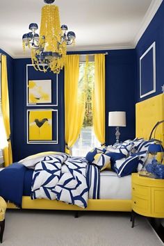 a yellow and blue bedroom with chandelier