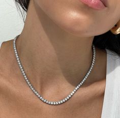 The Tennis NecklaceMetal: 18kt Gold Vermeil / Sterling Silver / 14kt Solid GoldStones: Cubic Zirconia (sterling silver / gold vermeil option)VVS Lab Stone Diamonds (14kt Gold Options)Length: 16”Chain Width: 3mm White Gold Tennis Necklace With 17 Jewels, Timeless Silver Tennis Necklace With 17 Jewels, White Gold Tennis Necklace Gift, White Single Strand Tennis Necklace For Gift, Timeless Tennis Necklace With Vvs Clarity As A Gift, Dainty White Gold Tennis Necklace Gift, Single Strand Tennis Necklace As A Gift, White Fine Jewelry Tennis Necklace With Sparkling Stones, Fine Jewelry White Tennis Necklace With Sparkling Stones