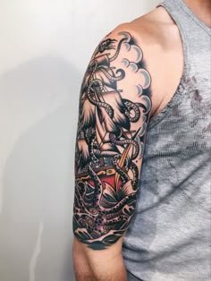 a man's arm with a ship and anchor tattoo on the left side of his arm