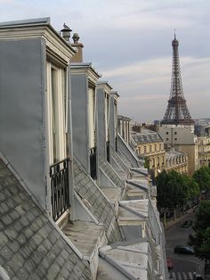 the eiffel tower is in the distance behind some buildings