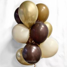 a bunch of balloons that are brown and white