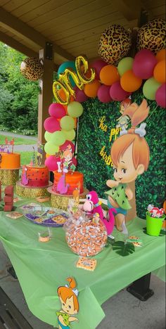 an outdoor birthday party with balloons and decorations